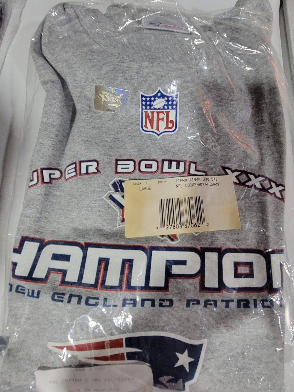 NIPThis is a gray New England Patriots t-shirt celebrating their Super Bowl XLIX